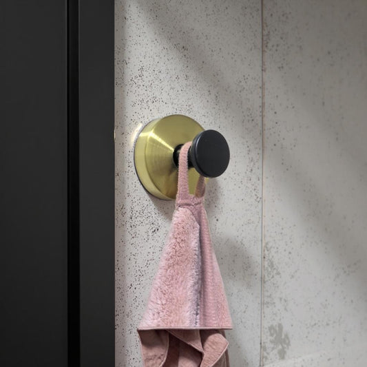 Stilren väggkrok i guld och svart